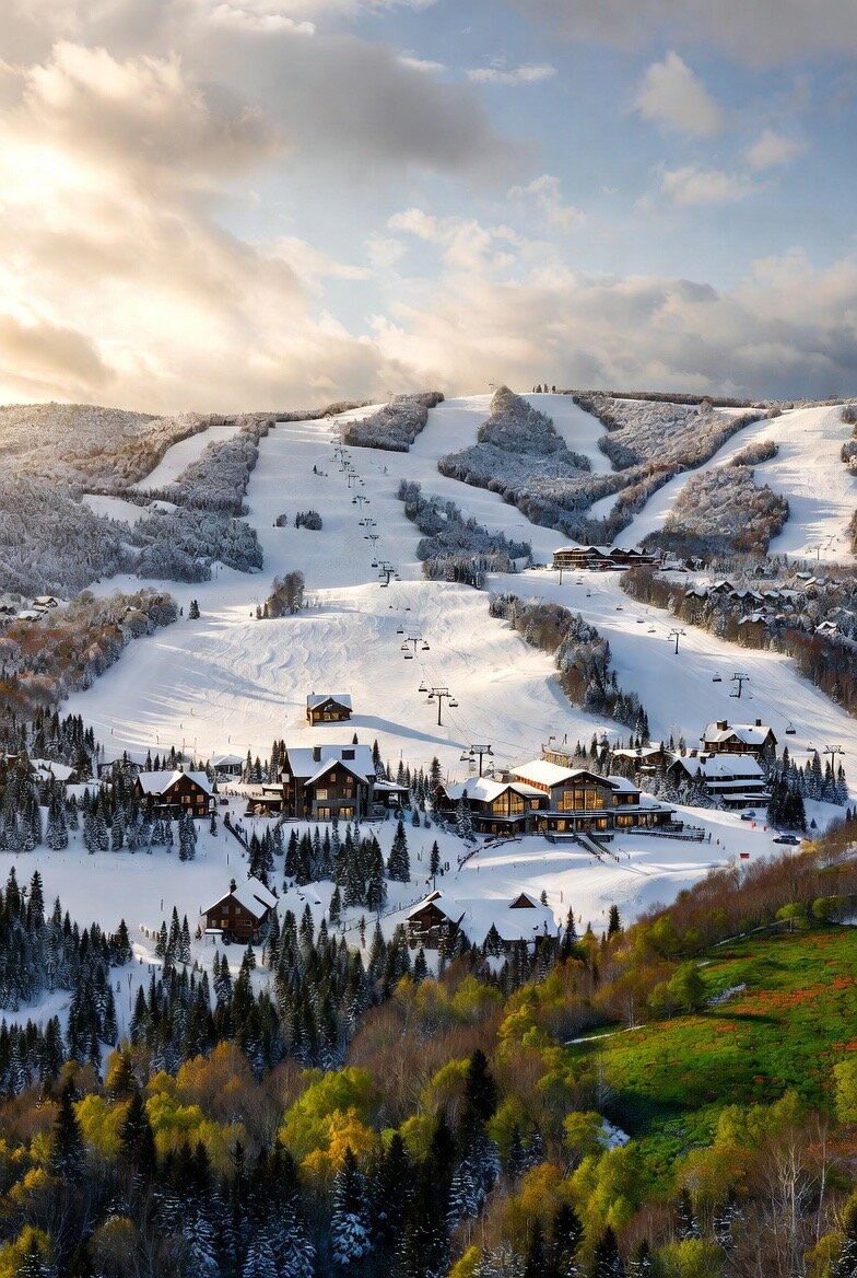Snowmaking equipment at dusk overlooking a mountain valley